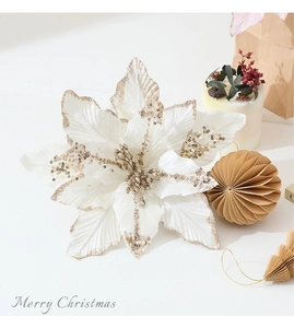 Detail of cream velvet Christmas poinsettia flower with sparkling gold glitter accents