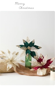 Detail of red and white velvet Christmas flowers with gold sequins in holiday decor