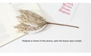 Close-up of golden sequin Christmas artificial flower petals with adjustable wire stem