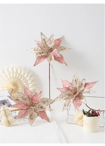 Detail of handmade pink and champagne poinsettia flowers with gold glitter for Christmas
