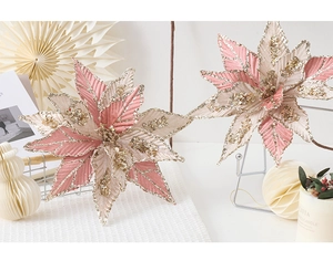 Detailed close-up of handmade pink fabric Christmas flowers with gold sequins and beads
