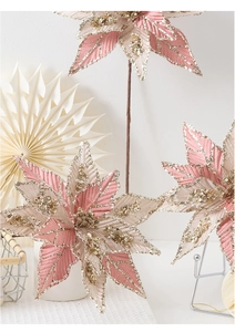 Macro detail of pink and champagne artificial poinsettia with gold sequins and beads