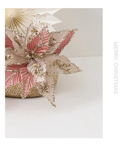 Close-up of pink Christmas poinsettia flower with gold glitter and sequins detail