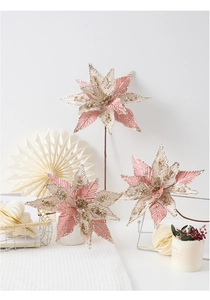 Detail of pink and gold artificial poinsettia with glitter and champagne petals