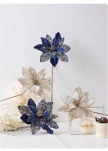 Close-up of artificial blue and gold poinsettia flowers with glitter for Christmas decor