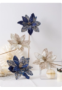 Macro detail of artificial Christmas poinsettias with champagne sequins and blue petals