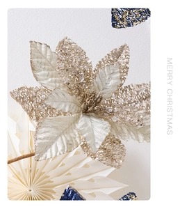 Macro detail of champagne gold poinsettia flower with sequins and bead embroidery