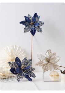 Detailed view of high-grade velvet Christmas poinsettia with blue sequins and long stems