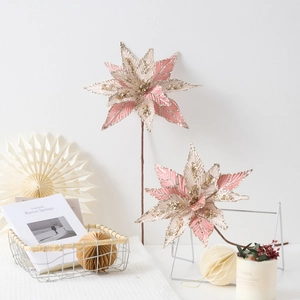 Pink and champagne poinsettia Christmas flowers with sequins for festive decoration