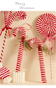 Detail of red and white velvet candy cane and lollipop ornaments with pine and bell accents