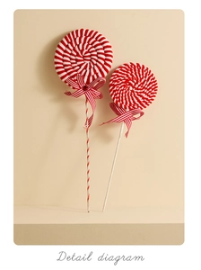 Detail view of plush red and white striped lollipop Christmas ornaments with ribbon bows