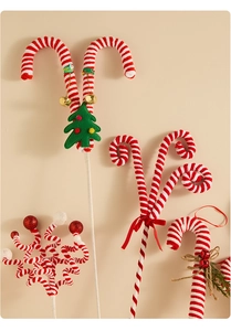 Detail of red and white striped candy cane sticks with bells and velvet tree decor