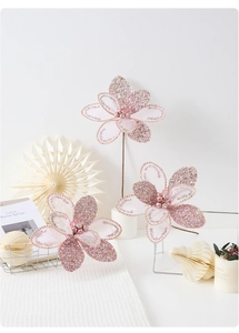 Detailed close-up of pink glitter Christmas flower with mesh petals and pearl center