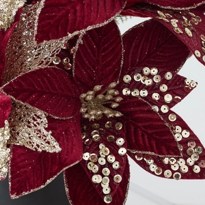 Elegant red velvet poinsettia Christmas flower with gold sequins and glitter accents