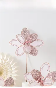Detail of pink glitter Christmas flower with mesh petals and rhinestone center for decor