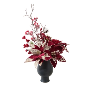 Elegant red poinsettia and gold berries in a black vase for Christmas tabletop decor