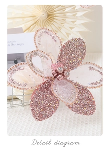 Close-up of pink glitter Christmas flower with mesh embroidery and bead details