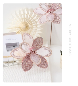 Close-up of pink glitter Christmas flowers with sequins and beads for tree decoration