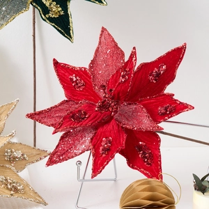 Red velvet Christmas poinsettia with glitter petals on a metal stand for holiday decor