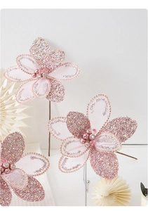 Close-up of pink glitter Christmas flower ornaments with pearls for tree decoration