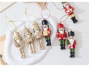 Detail of six resin nutcracker soldier ornaments in gold and classic festive colors