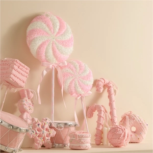 Pink and white candy-themed Christmas ornaments set with lollipops and donuts