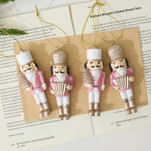 Set of four pink and gold resin nutcracker soldier ornaments for Christmas tree decoration