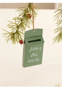 Close-up of green festive metal mailbox ornament with Letters for Santa text hanging on a tree