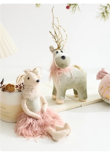 Detail of plush reindeer Christmas ornaments with pink feather skirts and gold glitter antlers