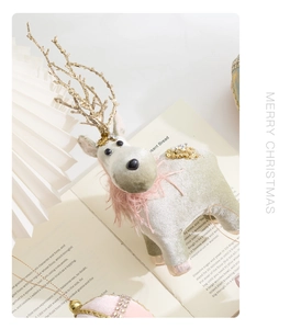 Detail of a velvet reindeer ornament with gold antlers and sequins for Christmas trees