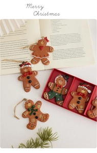 Set of five retro hand-painted gingerbread man resin ornaments with strings in a gift box
