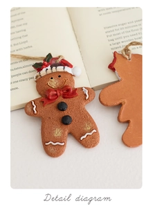 Detail of a resin gingerbread man ornament with hand-painted icing and rustic jute string