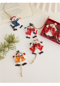 Detailed close-up of resin snowman ornaments with festive scarves and retro hanging cords