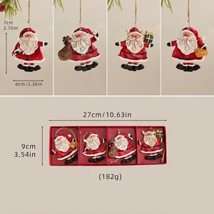 Detail view of 4-piece set of resin Santa Claus ornaments with hanging twine and red box