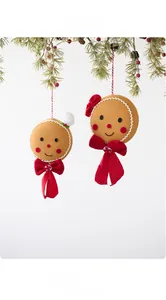 Detailed plush gingerbread man ornaments hanging on a Christmas tree branch