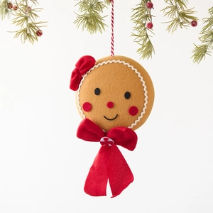 Handmade gingerbread man plush ornament with festive pine and red berry decoration