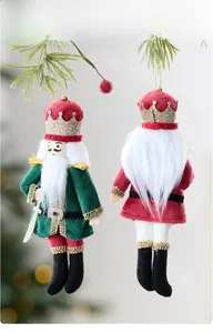 Close-up of velvet nutcracker soldier ornaments with sequins on Christmas tree branch