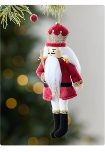 Close-up of a red velvet nutcracker soldier hanging ornament on a festive Christmas tree