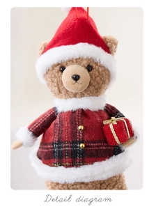Detail of plush Christmas teddy bear with red plaid coat and festive gift box