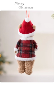Detail of Christmas teddy bear ornament featuring red plaid outfit and warm holiday lighting