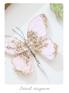 Close-up of pink velvet butterfly ornament with gold glitter and faux pearls