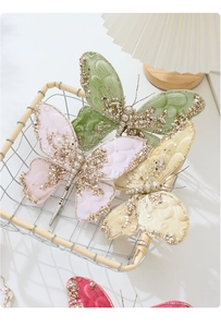 Detailed view of velvet butterfly clips with golden sequins and beads for Christmas trees
