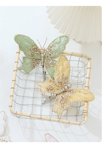 Detailed view of luxury fabric butterfly clips with sequins and beads for festive decor
