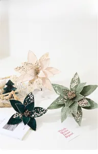 Macro shot of artificial velvet poinsettia flowers with glitter edges for holiday decor