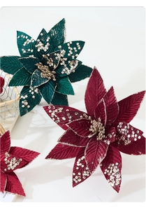 Macro shot of 25cm velvet Christmas poinsettia with glitter sequins and realistic stamens