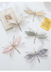 Detail of colorful velvet mesh butterfly clips with glitter edges for wedding decor