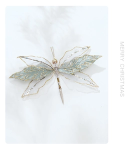 Close-up of turquoise velvet butterfly ornament with gold glitter and silver clip