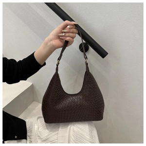 Detail of dark brown woven hobo bag with grid pattern and gold buckle adjustment