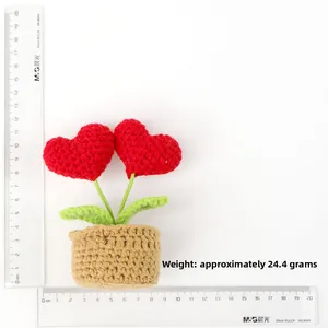 Macro detail of handmade crochet red heart potted plant decoration measuring 12cm in height
