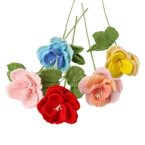 Handmade crochet flower bouquet with multi-color roses and green leaves for home decoration